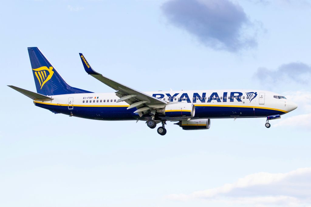 RyanAir aircraft flying midair among clouds