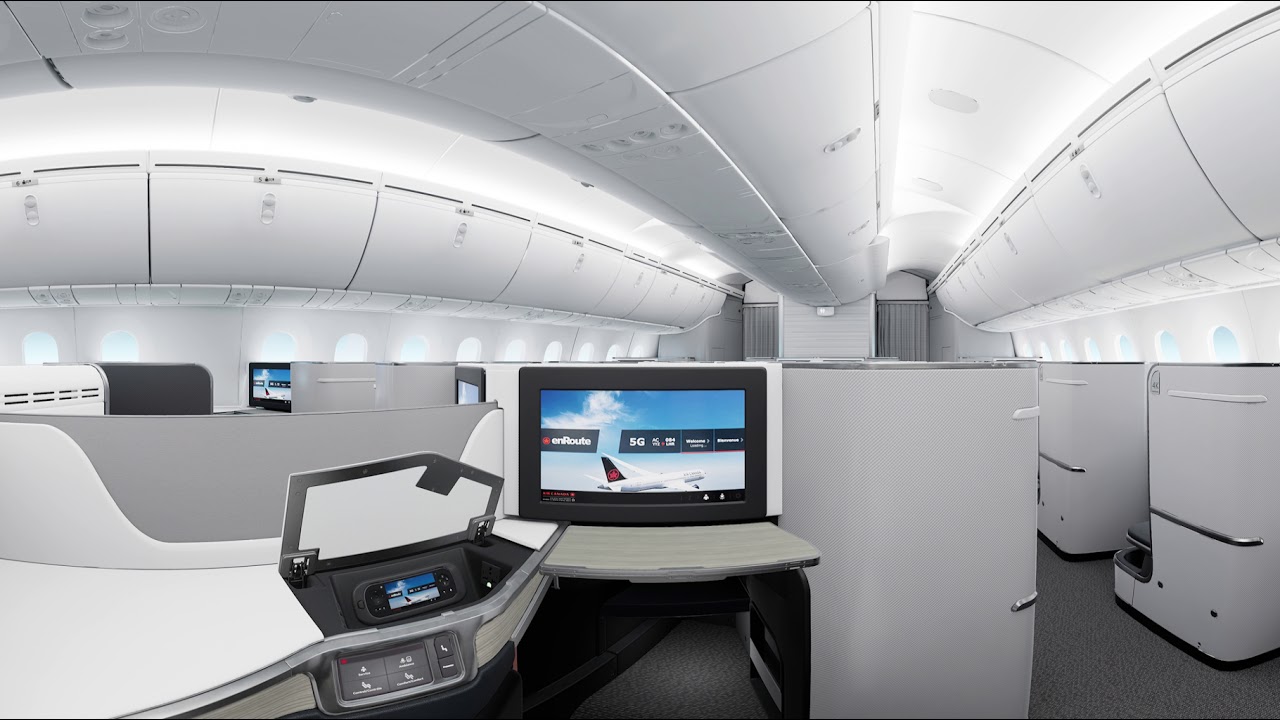 Air Canada signature class cabin in a sleek white design featuring television and fully reclining chair.