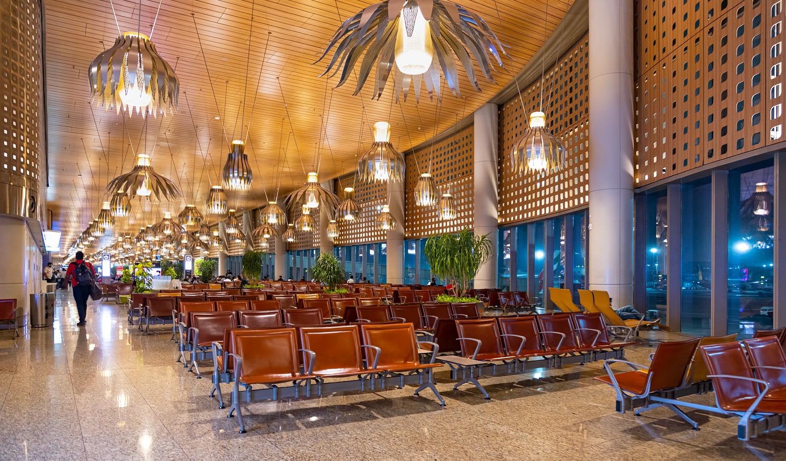 Departure lounge seating area inside Chhatrapati Shivaji Maharaj International Airport terminal at night.