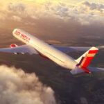 Photograph depicting the exterior of Air India aircraft cruising at altitude above the clouds.