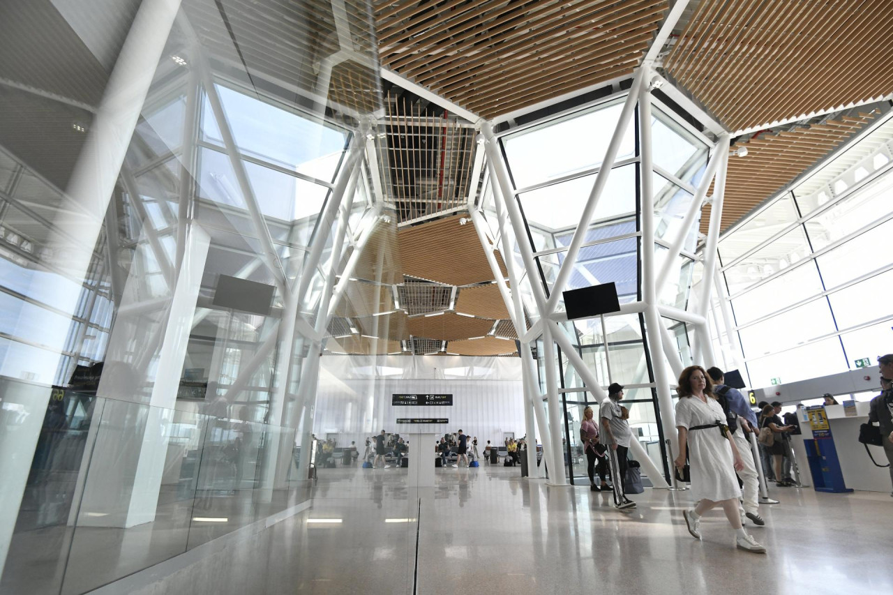 the inside of the new terminal featuring hexagonal shaped ceiling and glass panels