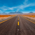 Solo traveler driving on an open roadway, during a long-distance, multi-state trip.