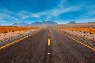 Solo traveler driving on an open roadway, during a long-distance, multi-state trip.