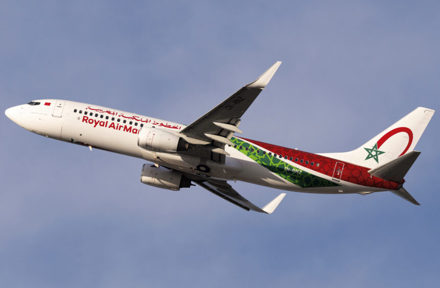 A Royal Air Maroc Boeing 737 mid-flight with a blue sky in the background.