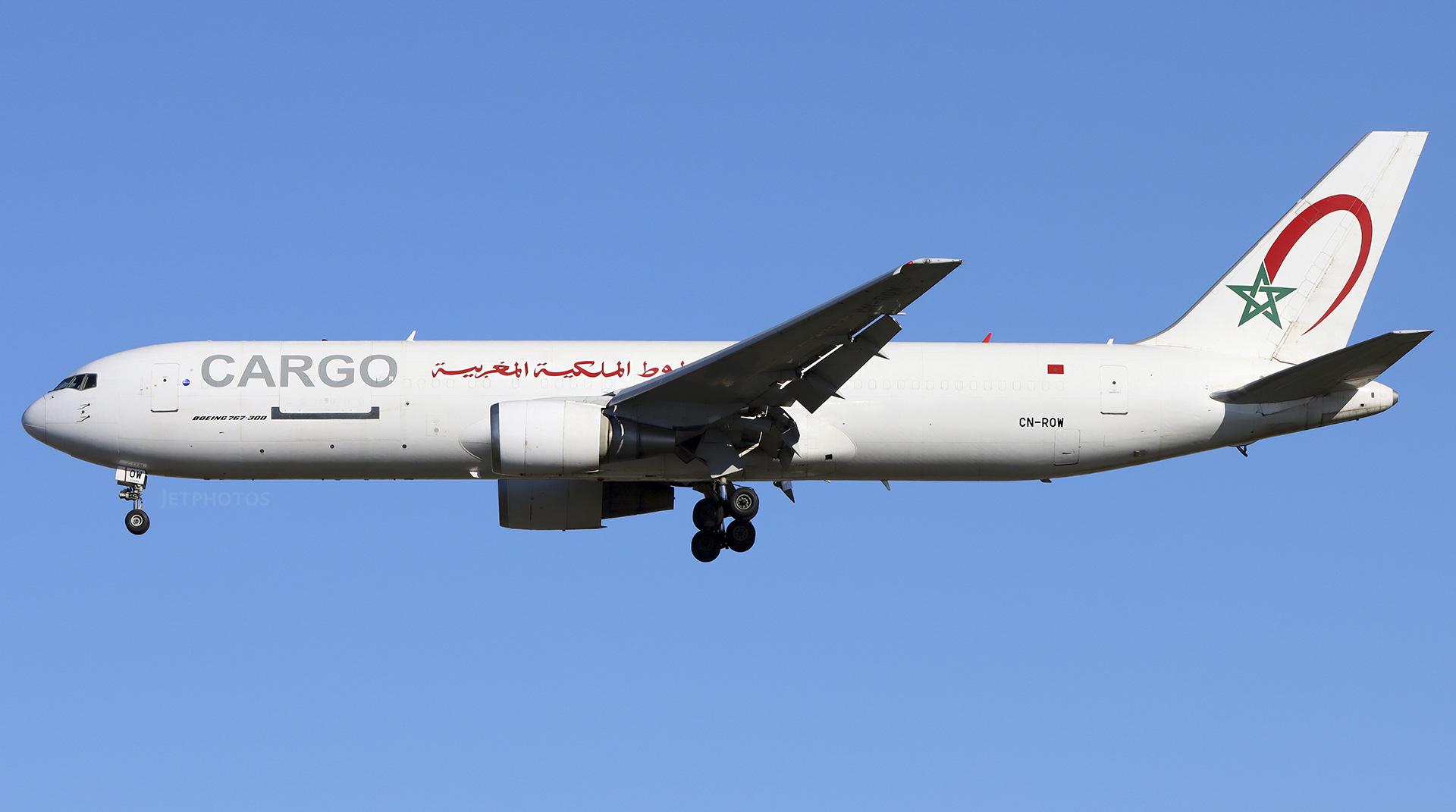 A Royal Air Maroc Cargo Boeing 767 plane mid-flight with a blue sky as the background.