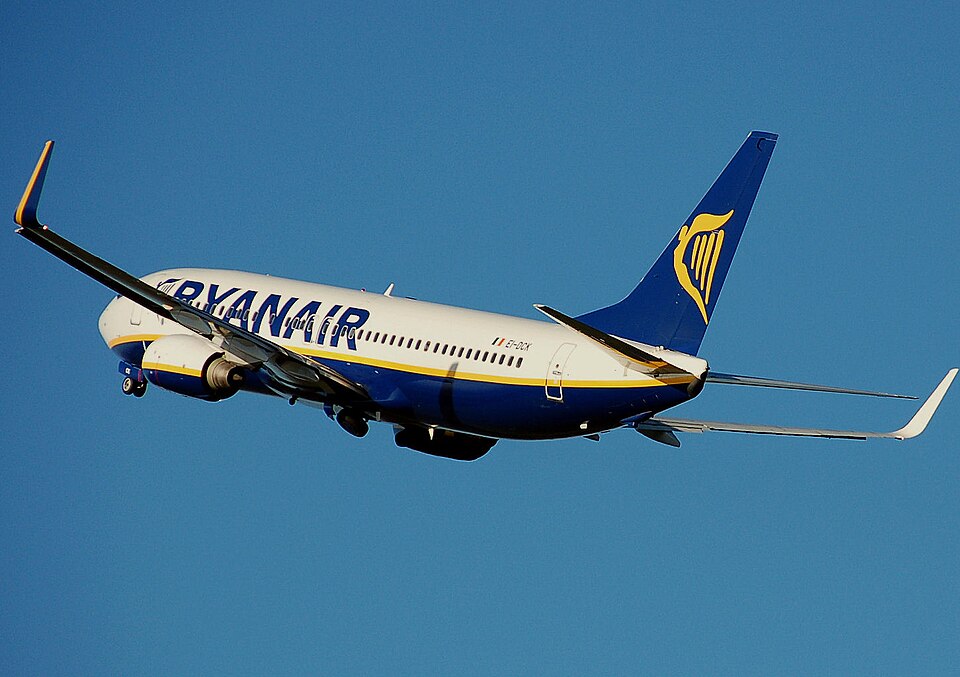 A Ryanair Boeing 737 ascending into the air midflight with a blue sky as the background. 