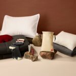 The signature class amemity kit laid out on a surface. Featuring pillow, duvet, eye mask, socks and skincare products.
