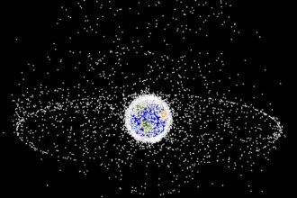 A computer-generated image of Earth surrounded by many white dots, each representing artificial objects launched into space by humans and which are currently being tracked.