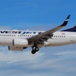 A WestJet Boeing 737-700 aircraft shown on its left-hand side