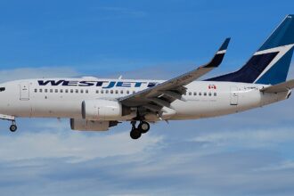A WestJet Boeing 737-700 aircraft shown on its left-hand side