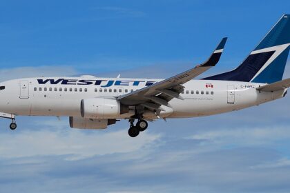A WestJet Boeing 737-700 aircraft shown on its left-hand side