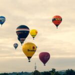 Image shows many hot air balloons in a dusky sky in 2015 at the 2025 Bristol International Balloon Fiesta