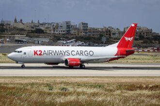 A K2 Airways Boeing 737-400F aircraft shown on its left-hand side