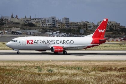A K2 Airways Boeing 737-400F aircraft shown on its left-hand side
