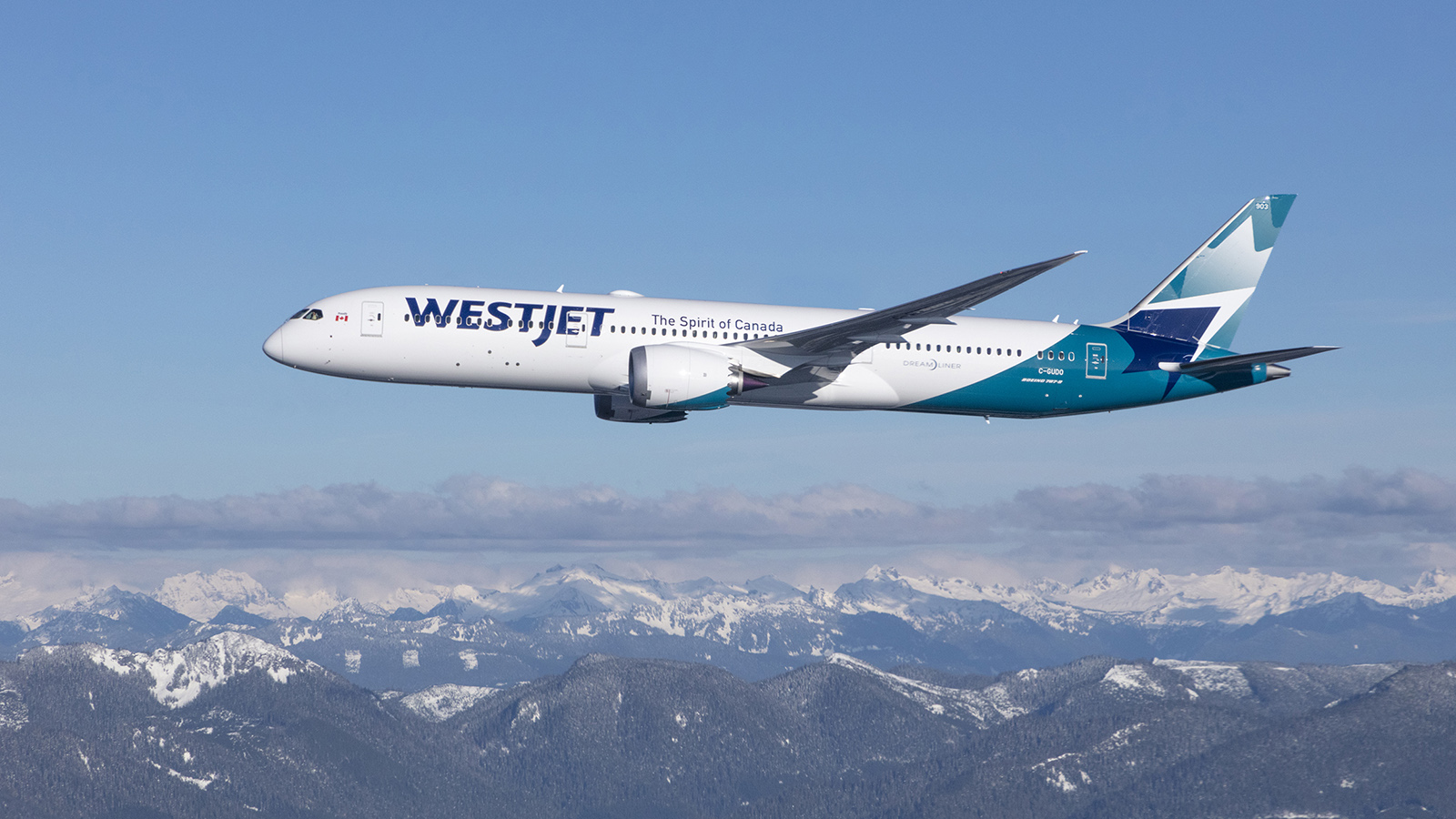 A Image of a WestJet Boeing 787-9 Dreamliner flying over rocky mountains