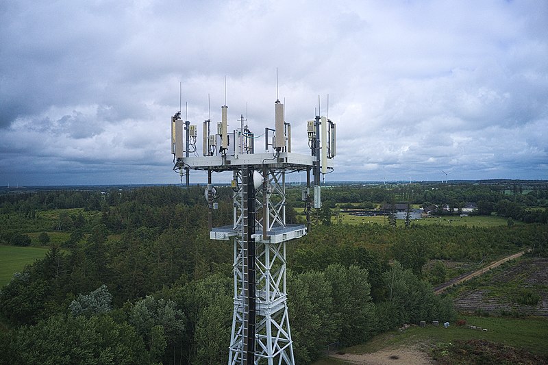 A Vodafone 5G mast holding many aerials and antennae in a forested area of Hattstedt, Germany.