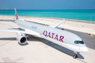Photograph depicting the exterior of a Qatar Airways long-haul aircraft on the runway.