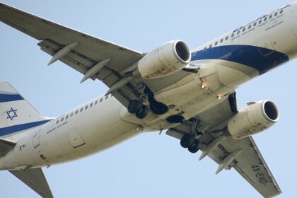 An El Al Boeing 767-300ER (registration 4X-EVO) photographed from below with its landing gear fully extended, showing the aircraft's underbelly, wing structure, and the prominent blue Star of David on the tail against a clear blue sky.