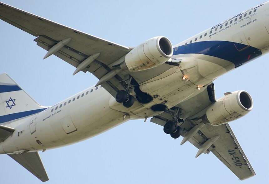 An El Al Boeing 767-300ER (registration 4X-EVO) photographed from below with its landing gear fully extended, showing the aircraft's underbelly, wing structure, and the prominent blue Star of David on the tail against a clear blue sky.