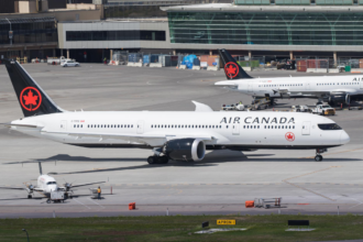 Air Canada fleet positioned on the runway ready for take-off at a busy airport