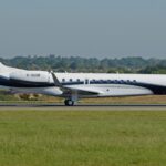 An Air Charter Scotland Embraer Legacy 650 aircraft shown on its right-hand side