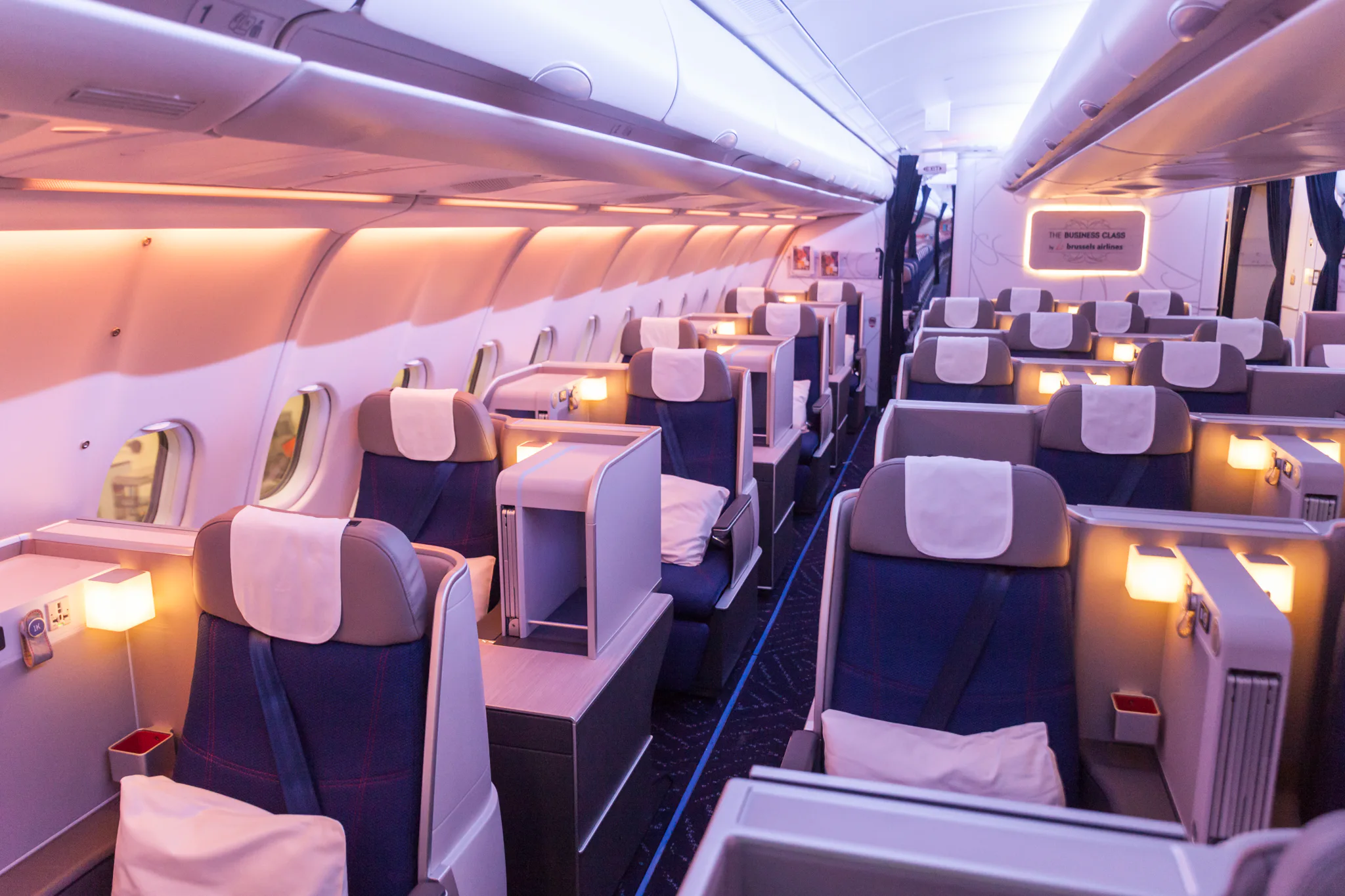 upgraded Business class cabin with blue coloured seats, cushions and individual lamps