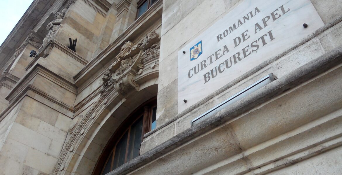 The entrance sign of Bucharest's Court of Appeal on the front of the building, shot from a low angle.