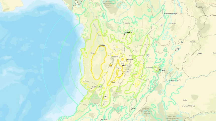 Map of western and central Colombia showing earthquake intensity zones overlaid on a terrain map. A yellow star marks the earthquake’s epicentre in the central-western part of the country, surrounded by irregular coloured contours indicating varying levels of shaking intensity. Concentric circular rings radiate outward from the epicentre, extending across the Pacific coast and inland regions. Major cities including Bogotá, Medellín, Cali and Pereira are labelled, along with rivers, roads and surrounding geographical features. The Pacific Ocean occupies the left side of the map, contrasting with the mountainous terrain and populated areas shown across Colombia.