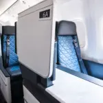 Inside a Delta aircraft, showing a Delta One suite seat.