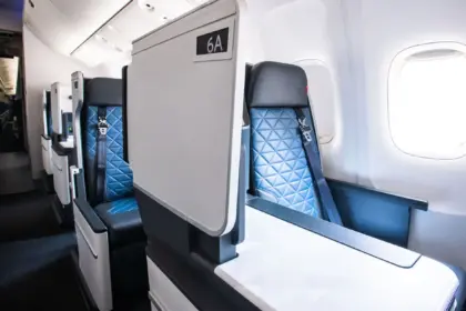 Inside a Delta aircraft, showing a Delta One suite seat.