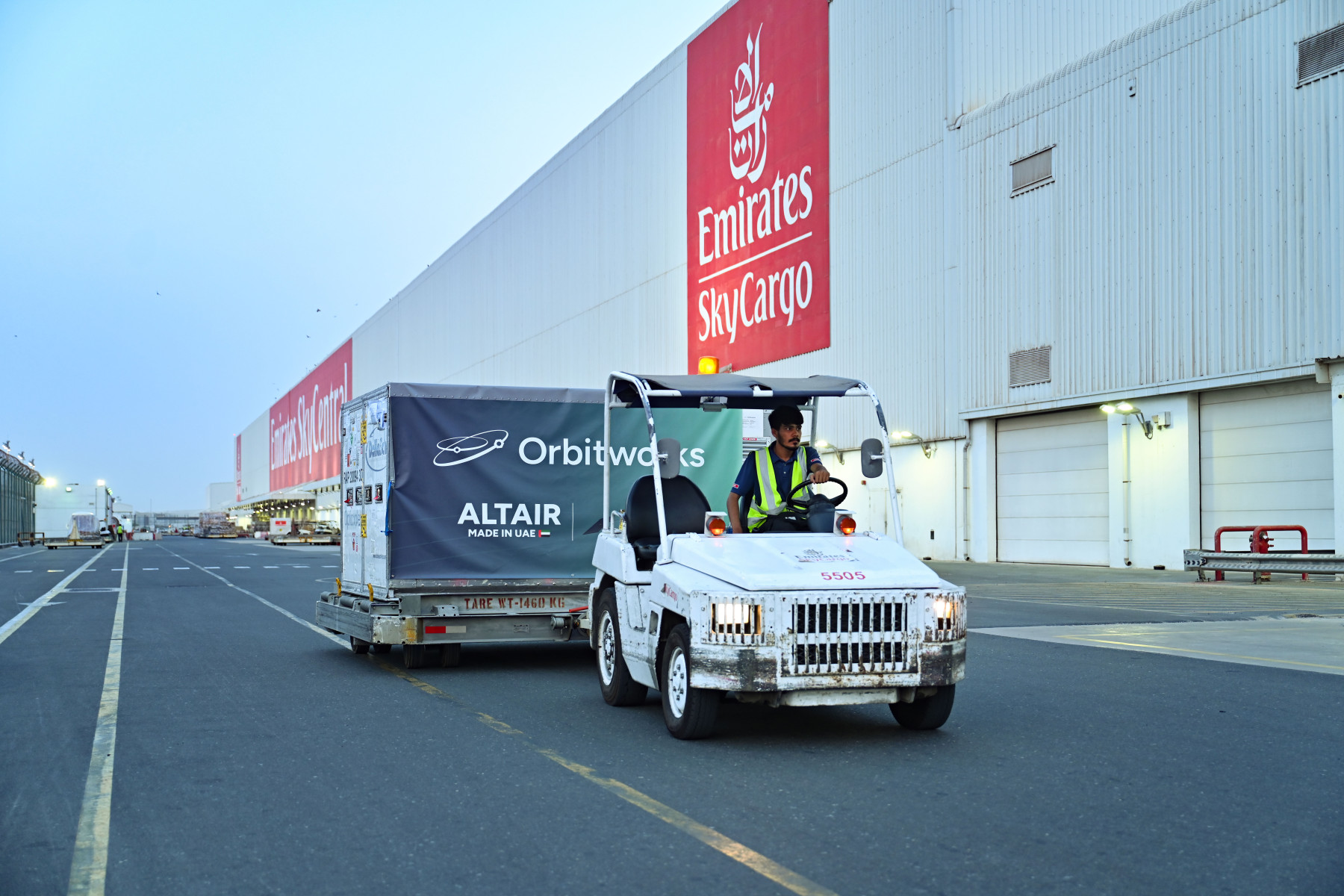 Photograph depicting Emirates SkyCargo ground staff transporting Altair-1 in a package.