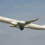 A now-retired Airbus A340-500 wearing the first livery with the old UAE coat of arms.