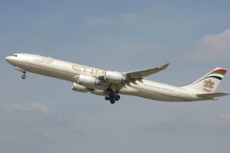 A now-retired Airbus A340-500 wearing the first livery with the old UAE coat of arms.