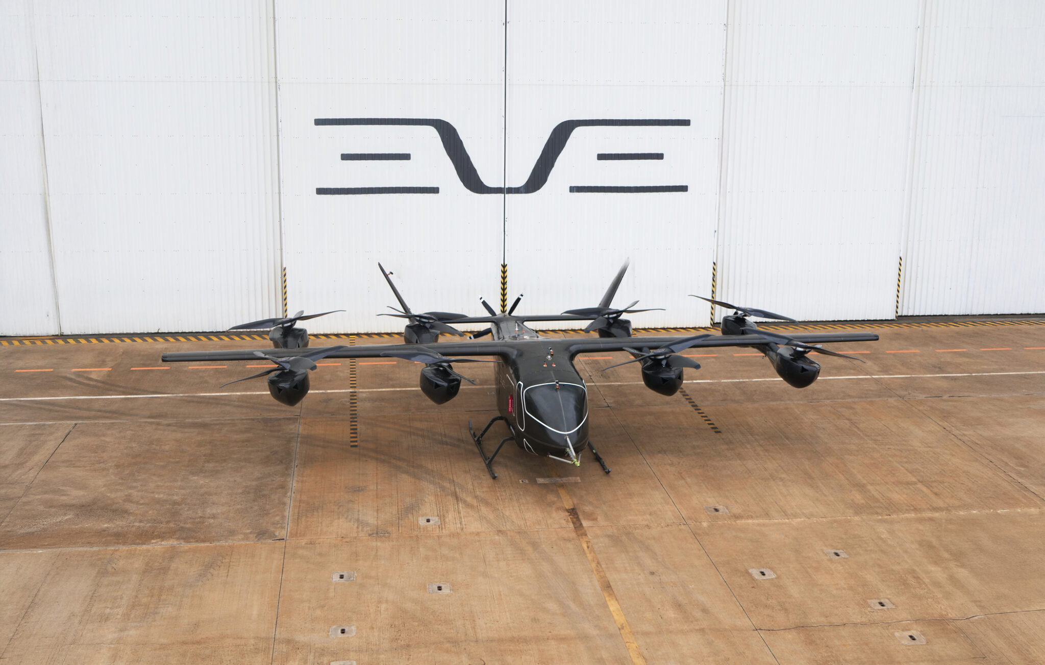 An image of an Eve Air Mobility eVTOL aircraft with the company's logo in the background.