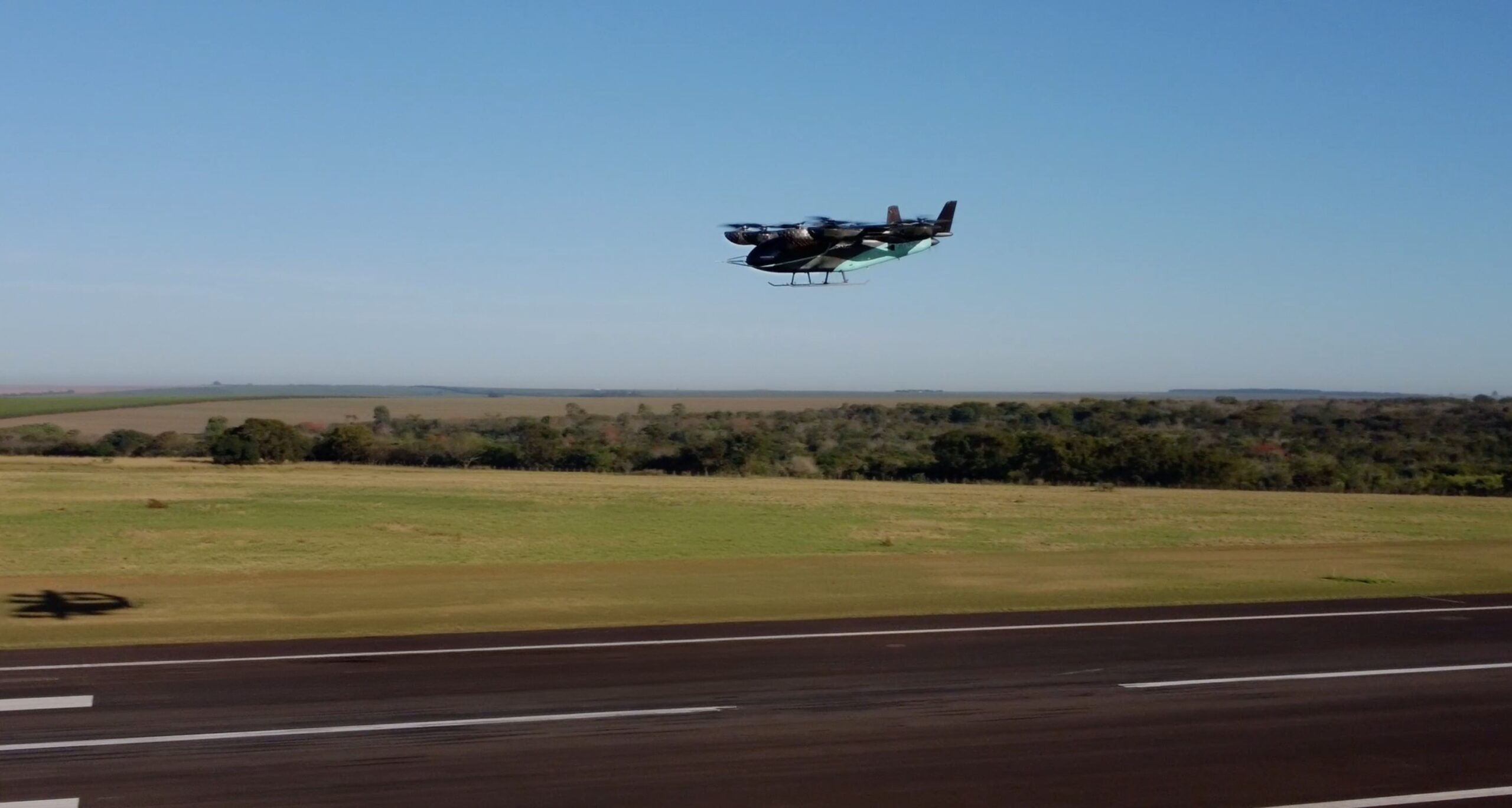 An image of an Eve Air Mobility aircraft prototype taking off from an runway