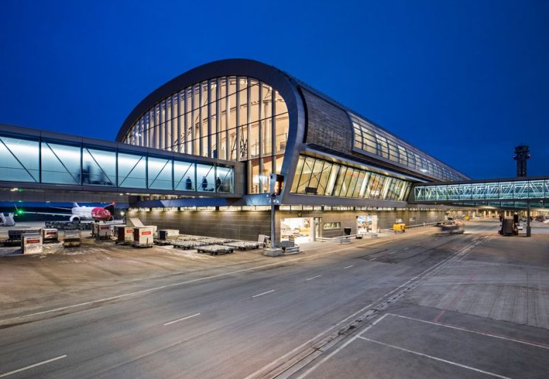 Gardermoen North Terminal exterior pictured at night.