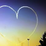Image shows a heart shaped aircraft trail in a colourful Cyprus sky