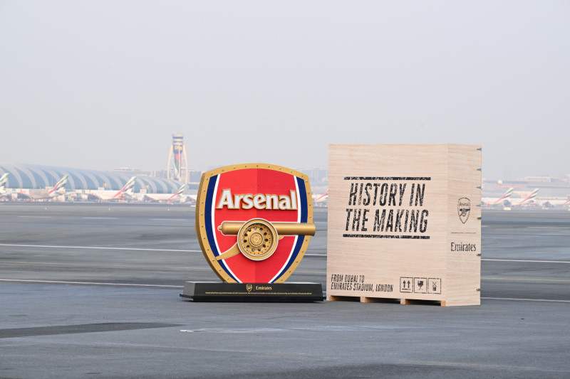 Photograph depicting the Arsenal logo positioned next to an Emirates crate entitled 'History in the Making'.
