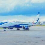 The Embraer E190 5N-CER on an airport runway, it is painted in Air Peace’s white and blue colours.