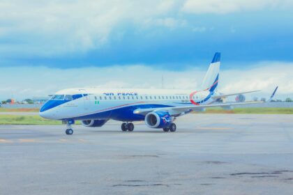 The Embraer E190 5N-CER on an airport runway, it is painted in Air Peace’s white and blue colours.