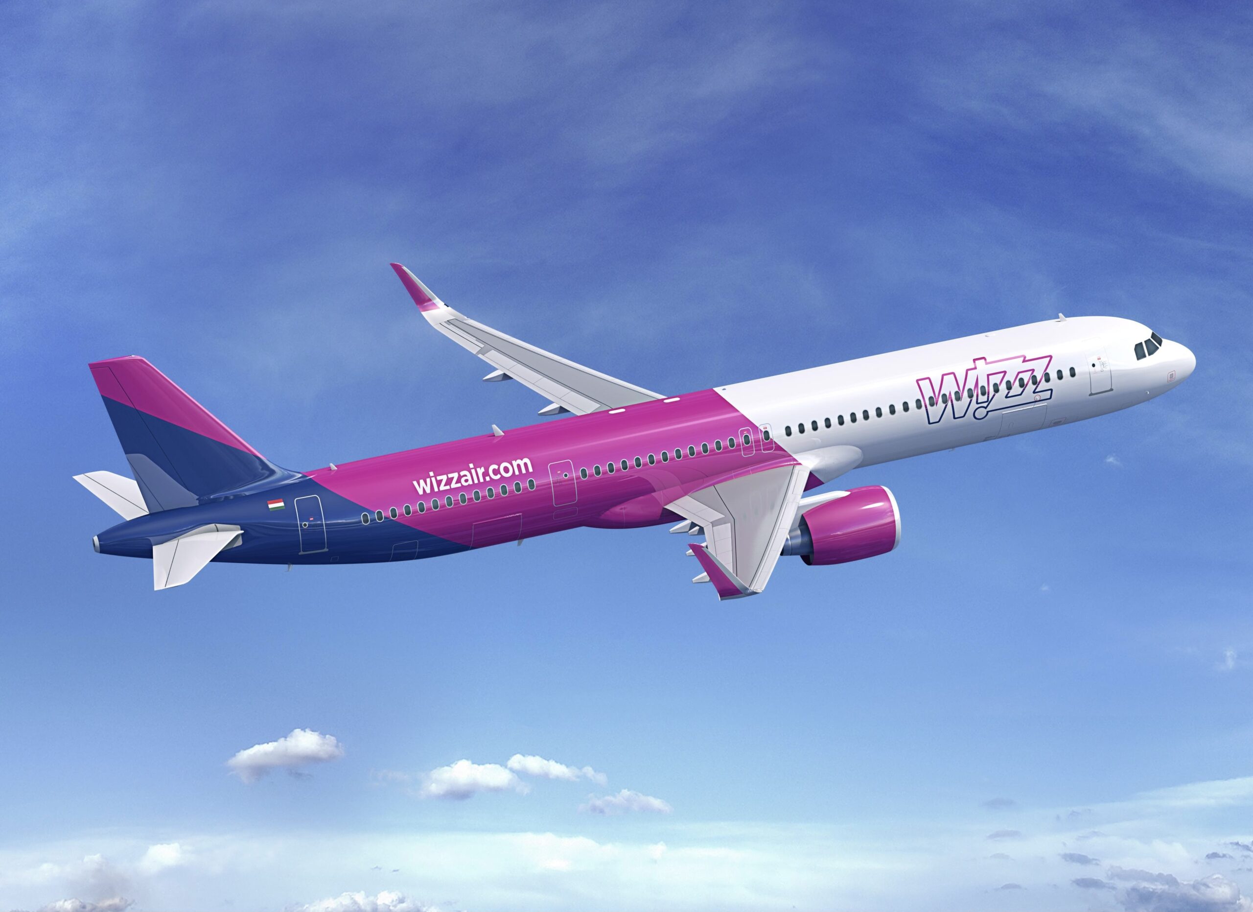 A purple, white, and blue, Wizz Air Airbus jet flying upwards. The sky behind is dark blue and cloudy.
