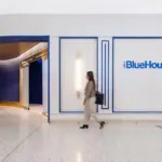 Person walking outside JetBlue's BlueHouse lounge at JFK.
