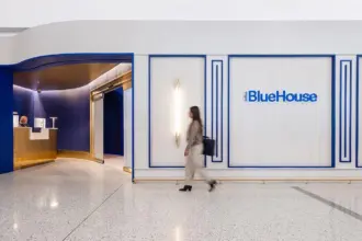 Person walking outside JetBlue's BlueHouse lounge at JFK.