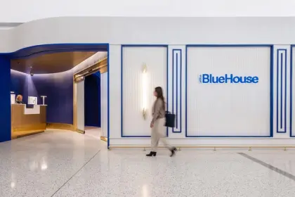 Person walking outside JetBlue's BlueHouse lounge at JFK.