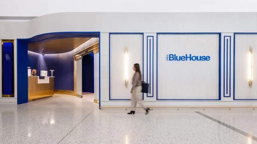 Person walking outside JetBlue's BlueHouse lounge at JFK.