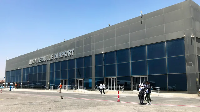 Outside the front of Mogadishu Aden Adde International Airport, against a blue sky.