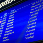 A departure board displaying delayed and cancelled flights out of Oslo Airport (OSL).