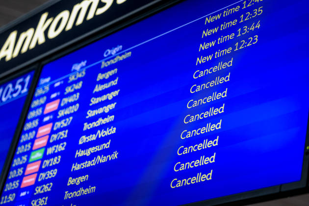 A departure board displaying delayed and cancelled flights out of Oslo Airport (OSL).