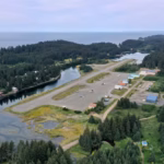 An aerial image of Seldovia Airport (SOV), which shows a short runway surrounded by water and forested land.