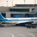 A Somali Airlines Boeing 707-338C parked at an airport gate.